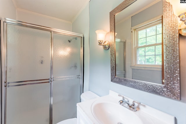 bathroom featuring toilet, a shower stall, and crown molding