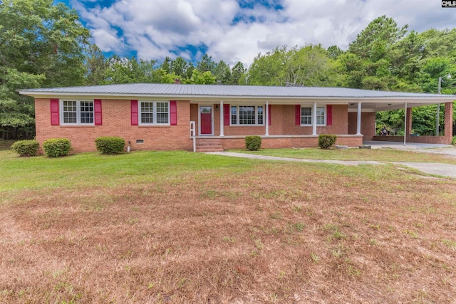 ranch-style house with brick siding, a front yard, crawl space, a carport, and driveway