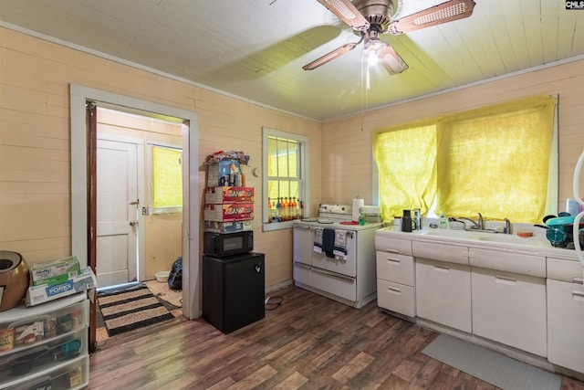 kitchen with white range with electric stovetop, dark wood-type flooring, white cabinets, a sink, and black microwave