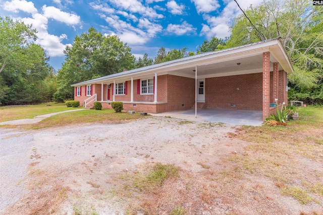 ranch-style house with an attached carport, brick siding, driveway, crawl space, and a front lawn