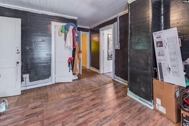 entrance foyer with ornamental molding and hardwood / wood-style flooring