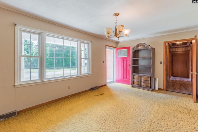 unfurnished room with carpet flooring, visible vents, baseboards, and an inviting chandelier