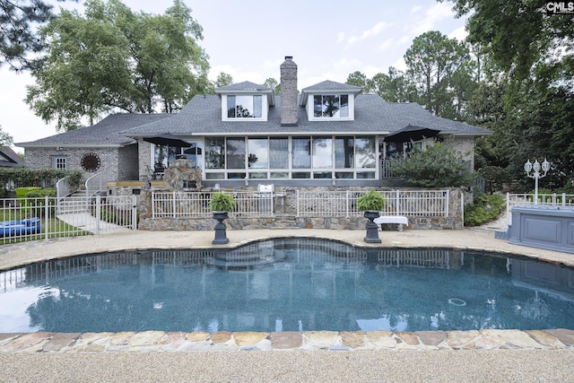 view of pool featuring a patio and a sunroom