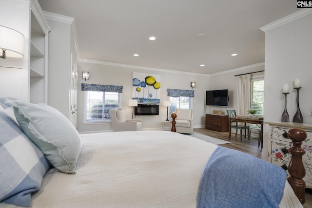 bedroom with wood-type flooring, multiple windows, and crown molding