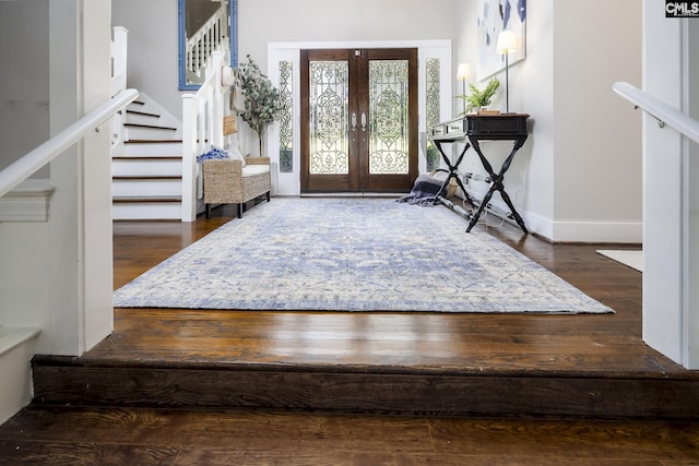 entrance foyer with dark hardwood / wood-style floors and french doors