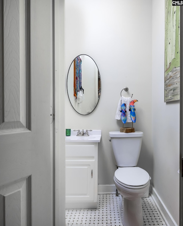 bathroom with tile patterned flooring, vanity, and toilet