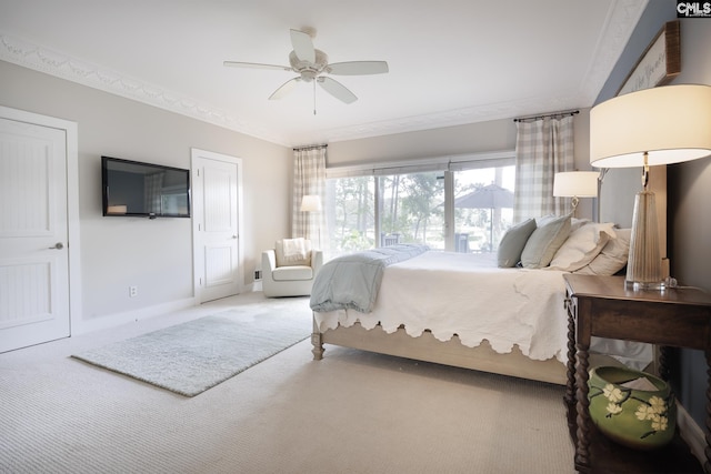 bedroom with carpet flooring, ceiling fan, and crown molding