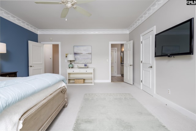 carpeted bedroom with ceiling fan and ornamental molding