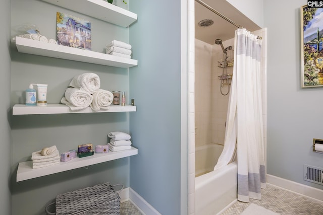 bathroom with tile patterned flooring and shower / bath combo with shower curtain