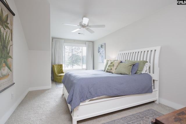 carpeted bedroom featuring ceiling fan and vaulted ceiling