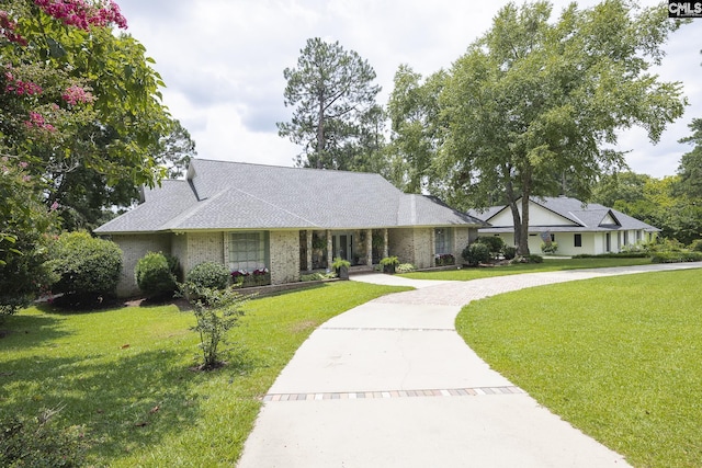 ranch-style home with a front lawn