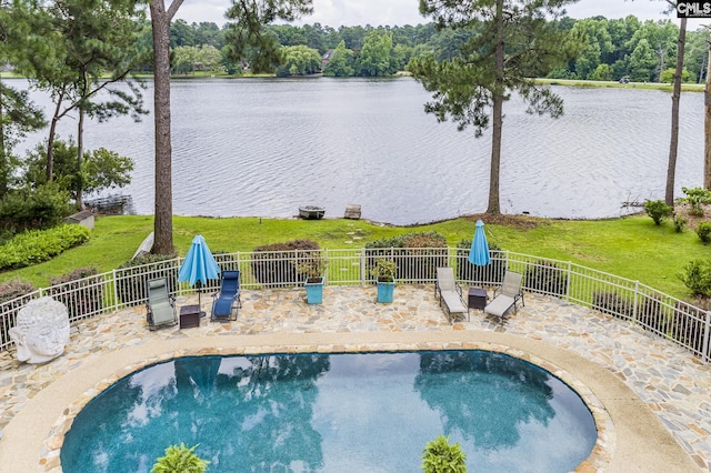 view of pool featuring a water view and a patio area