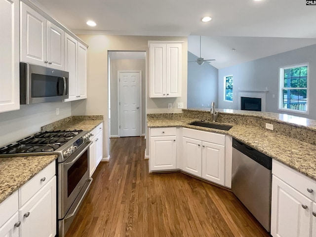 kitchen featuring dark wood-type flooring, white cabinetry, appliances with stainless steel finishes, ceiling fan, and sink