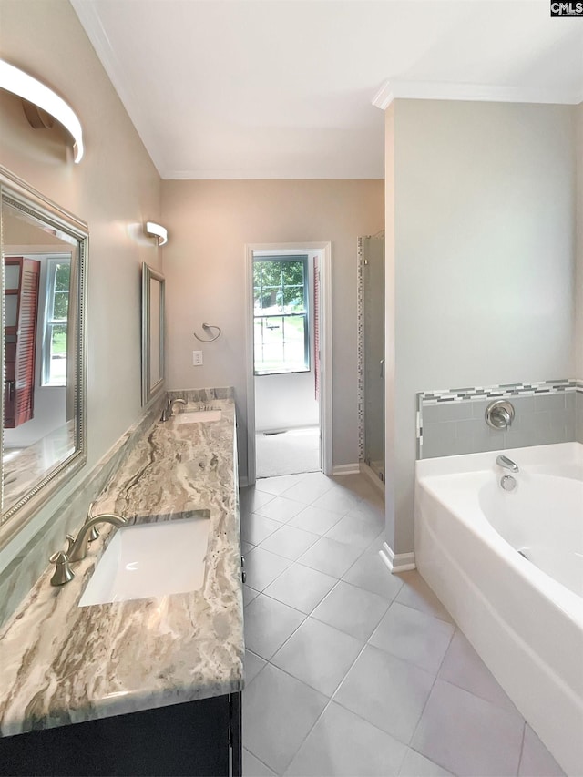 bathroom featuring a washtub, tile patterned flooring, ornamental molding, and vanity