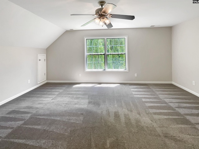 bonus room with ceiling fan, vaulted ceiling, and dark carpet