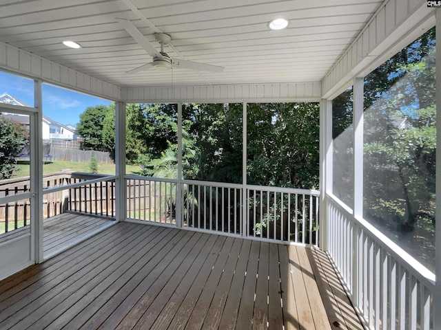 unfurnished sunroom with ceiling fan