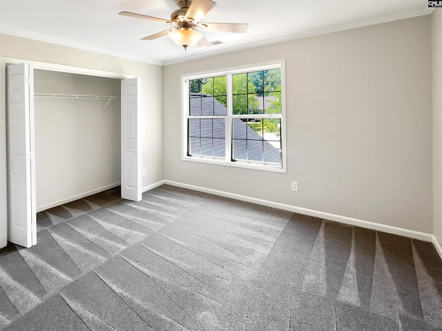 unfurnished bedroom with ceiling fan, crown molding, a closet, and carpet