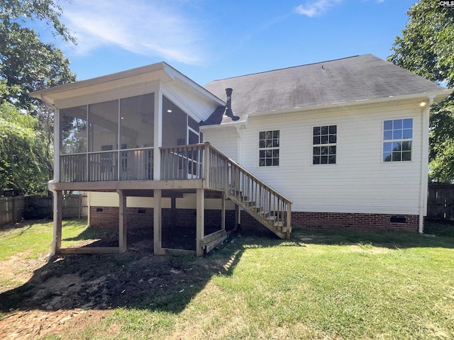 back of house featuring a deck, a yard, and a sunroom