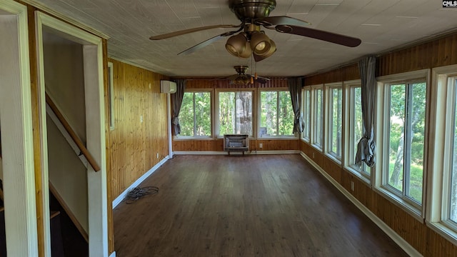 unfurnished sunroom featuring an AC wall unit and ceiling fan