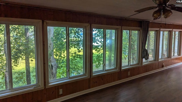 unfurnished sunroom featuring ceiling fan