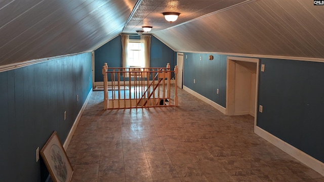 bonus room with baseboards and vaulted ceiling