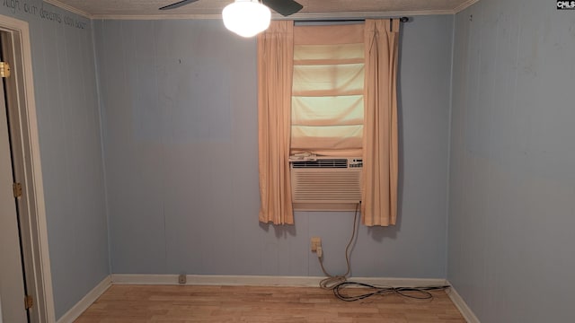 spare room with ceiling fan, light wood-type flooring, cooling unit, and crown molding