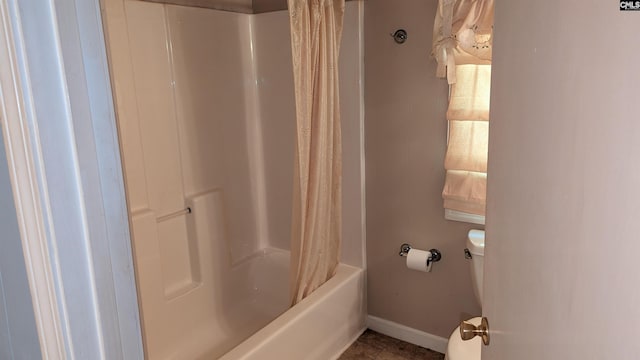 bathroom with toilet and baseboards