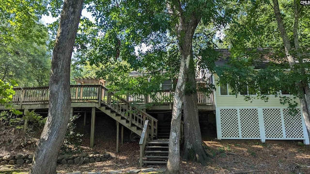 rear view of house featuring stairway and a wooden deck