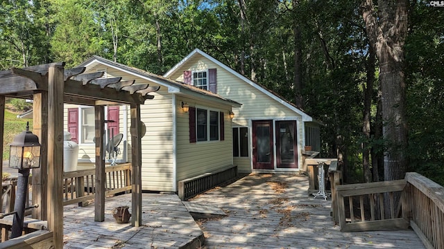 exterior space featuring a wooden deck and a pergola