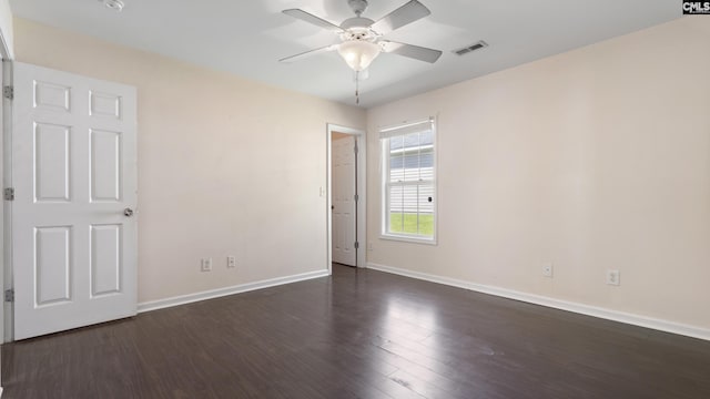 unfurnished room with ceiling fan and dark hardwood / wood-style floors