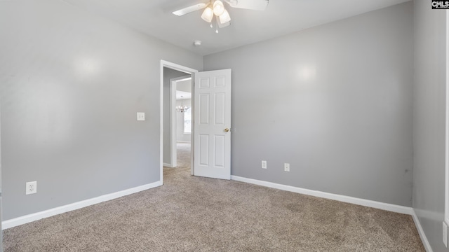 spare room with carpet and ceiling fan