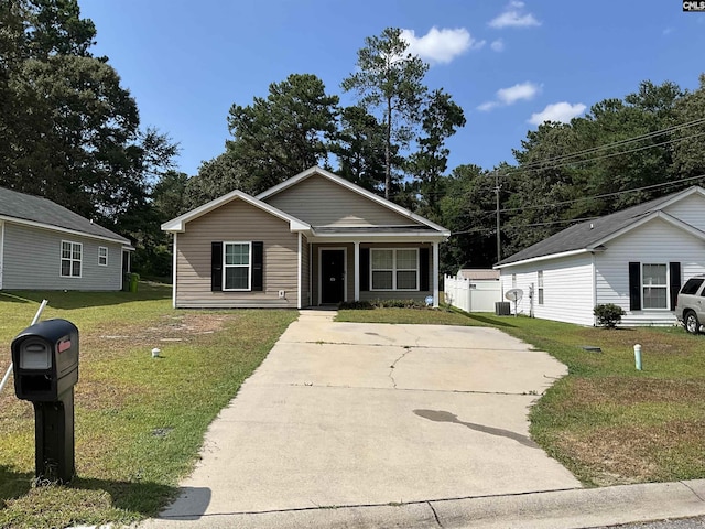 view of front of property featuring a front yard and cooling unit