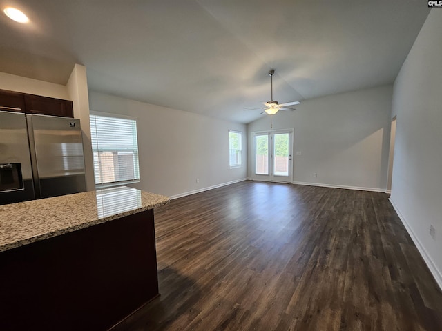 kitchen with appliances with stainless steel finishes, a kitchen island with sink, dark wood-type flooring, ceiling fan, and lofted ceiling