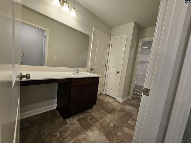 kitchen featuring appliances with stainless steel finishes, a kitchen island with sink, a healthy amount of sunlight, sink, and lofted ceiling