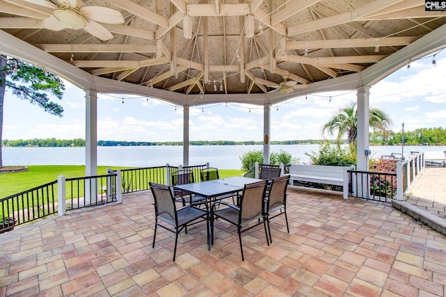 view of patio with a water view, a gazebo, and ceiling fan