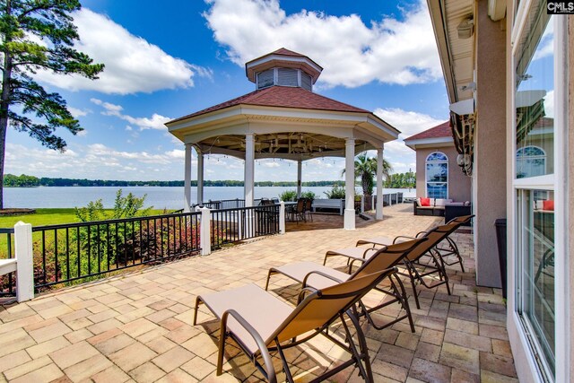 view of patio featuring a water view and a gazebo