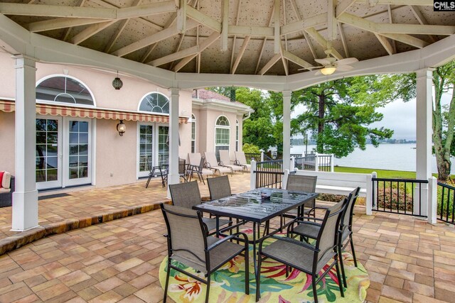 view of patio / terrace with a water view, ceiling fan, and a gazebo