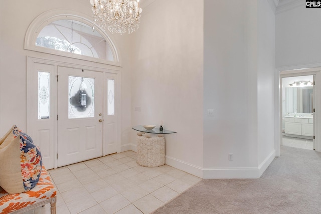 tiled foyer featuring a high ceiling and a notable chandelier