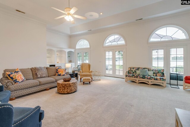 living room with crown molding, french doors, ceiling fan, and a wealth of natural light