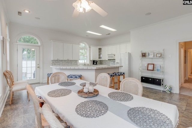 dining space featuring ornamental molding and ceiling fan