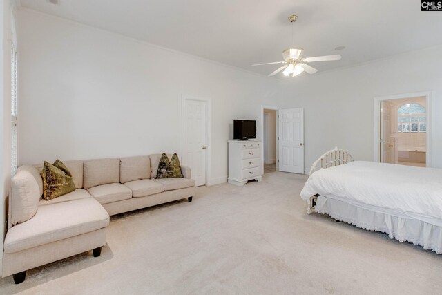 bedroom with carpet floors, crown molding, ceiling fan, and connected bathroom