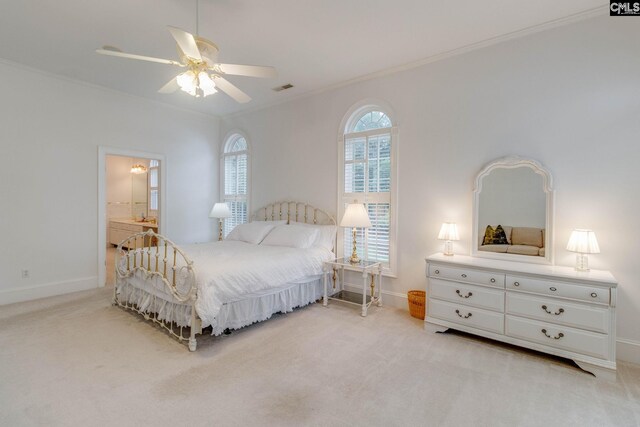 bedroom with ensuite bathroom, ceiling fan, ornamental molding, and light colored carpet