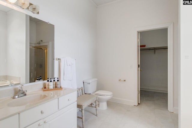 bathroom featuring tile patterned flooring, walk in shower, toilet, and vanity