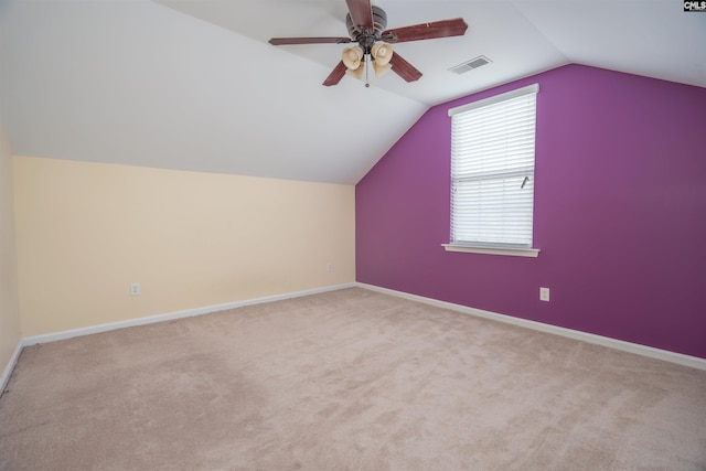 additional living space featuring carpet floors, ceiling fan, and vaulted ceiling