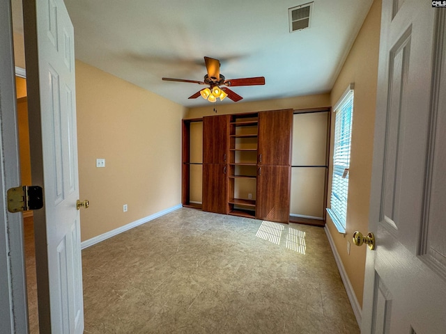 unfurnished bedroom with ceiling fan and tile patterned floors