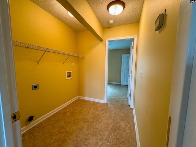 washroom with tile patterned flooring, hookup for a washing machine, electric dryer hookup, and a textured ceiling