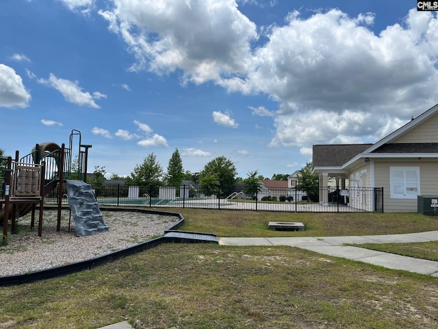 view of yard featuring a playground and central AC unit