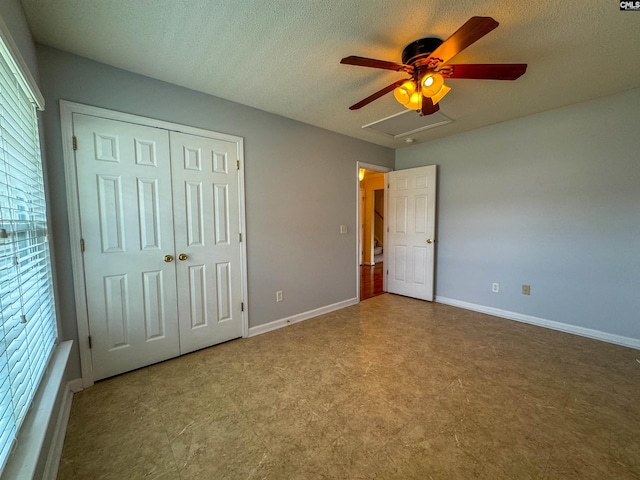 unfurnished bedroom featuring a closet, tile patterned floors, a textured ceiling, and ceiling fan