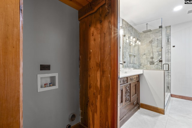 bathroom featuring vanity, toilet, and a shower with shower door