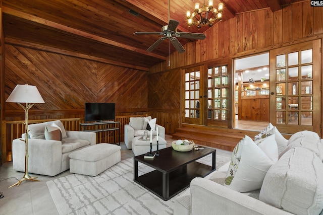 living room featuring wood ceiling, ceiling fan with notable chandelier, light tile patterned floors, vaulted ceiling with beams, and wood walls